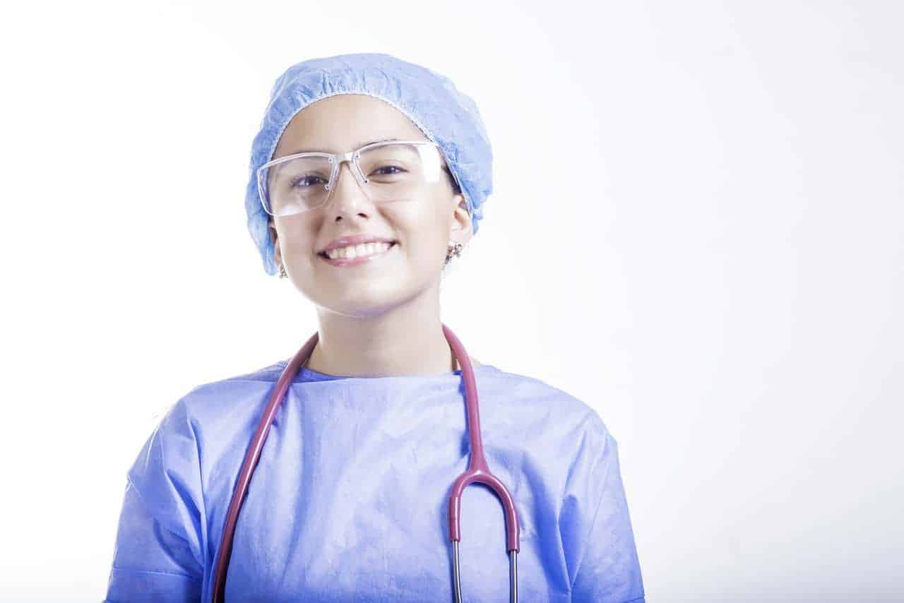 A smiling nurse with a stethoscope around her neck. Her nursing school personal statement was accepted when she applied into a nursing program.