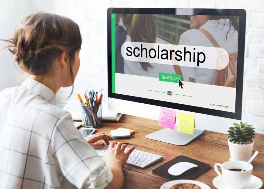 A lady searching for scholarships, and preparing to write a scholarship personal statement